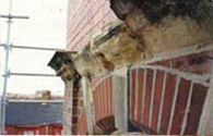 Sandstone cornice before repair, severe erosion Sandstone cornice before repair